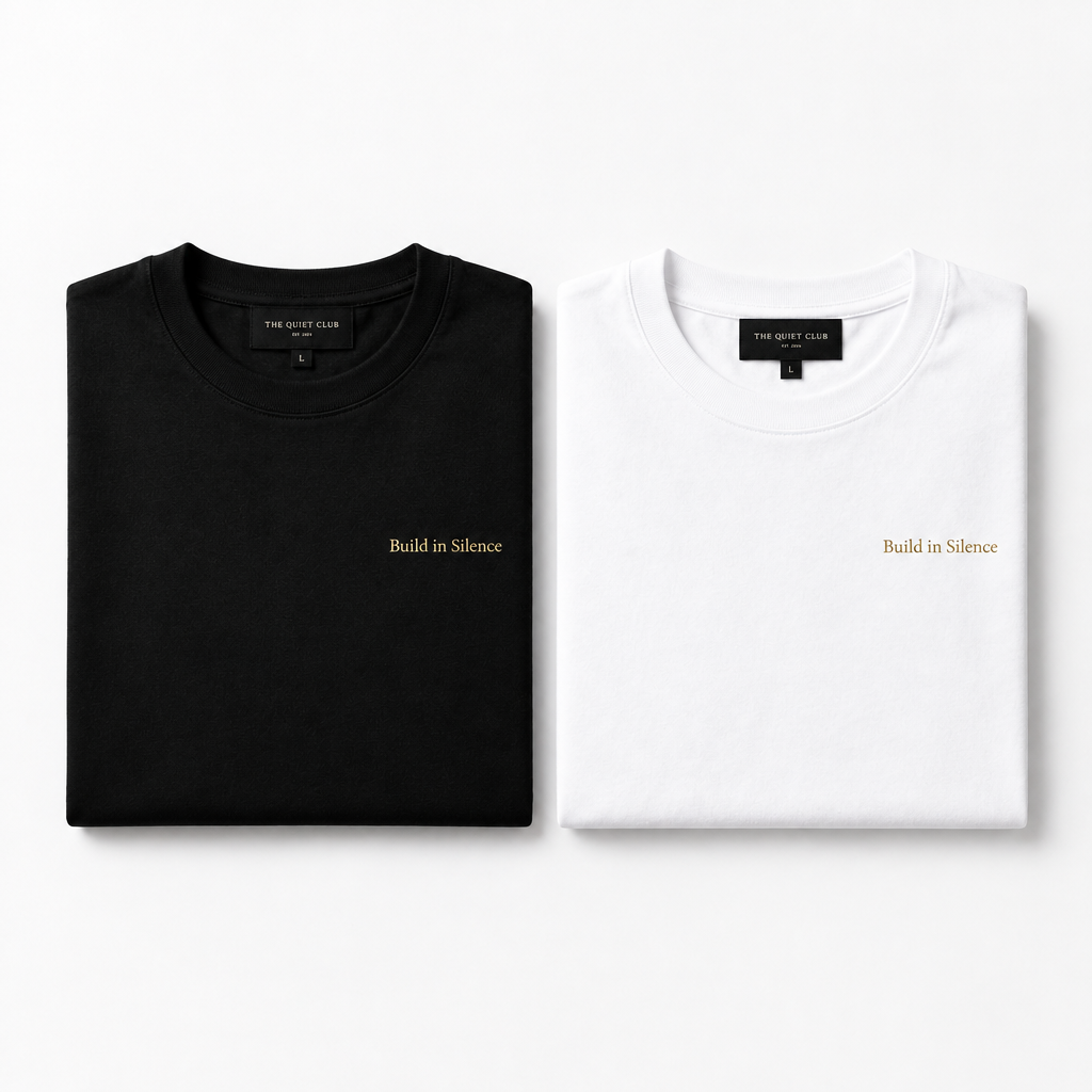 Build in Silence tee — black and white versions flat lay