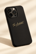 Matte black iPhone 16 Pro phone case angled cream background gold The Architect signature